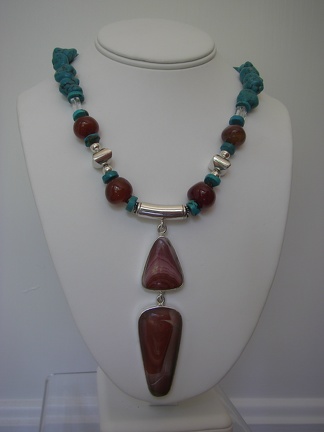Red jasper sterling double pendent on carnelian with turquoise and sterling silver accents.  Expandable sterling toggle. 